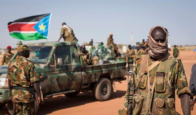 In this Sunday, Jan 12, 2014 file photo, South Sudanese government forces from the "Lion division" cheer their recent victory, after government forces on Friday retook from rebel forces the provincial capital of Bentiu, in Unity State, South Sudan.