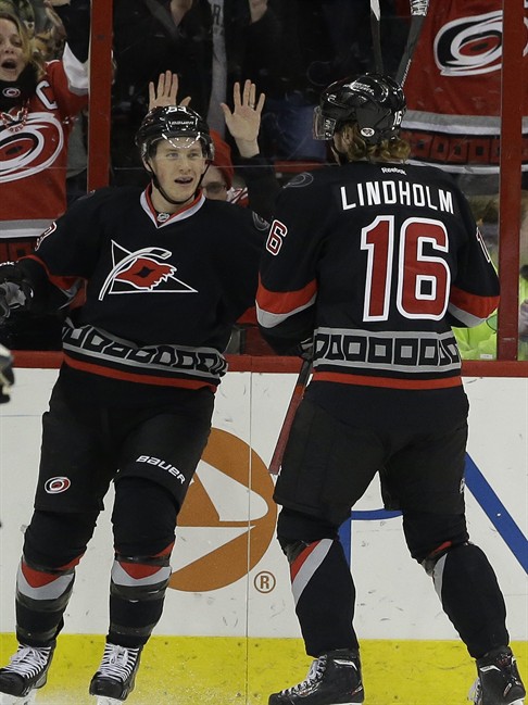 Carolina Hurricanes' Jeff Skinner, left, celebrates his goal against the Toronto Maple Leafs with Elias Lindholm (16), of Sweden, during the first period of an NHL hockey game in Raleigh, N.C., Thursday, Jan. 9, 2014. Carolina won 6-1. (AP Photo/Gerry Broome).