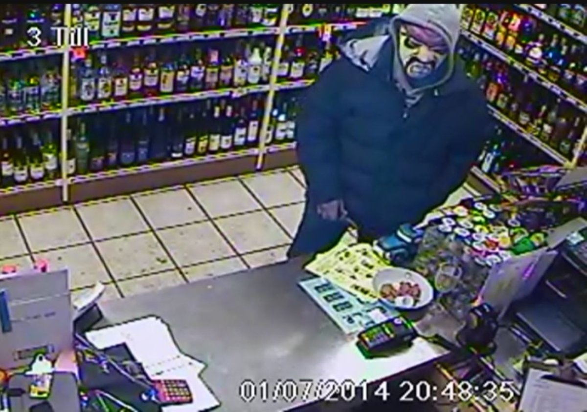 Surveillance photo of armed robbery suspect.