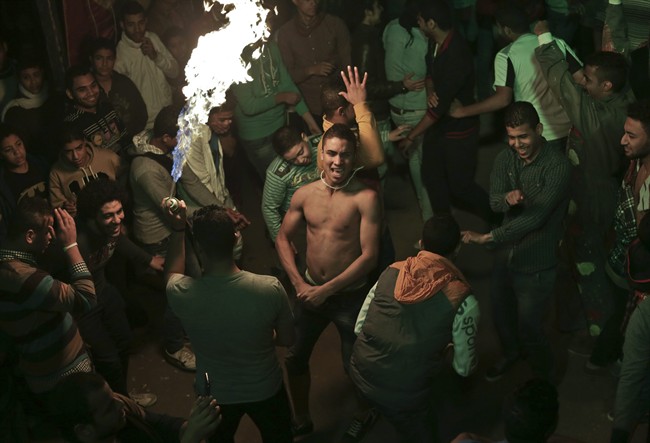 In this Thursday, Dec. 19, 2013 photo, Egyptian youths dance, to music during a bachelors party, in El-Marg, a suburb northeast of Cairo, Egypt. 