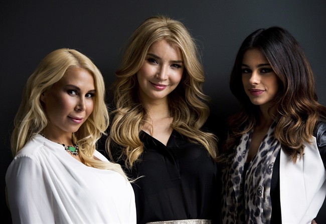 Transgender model and former Miss Universe Canada contestant Jenna Talackova (centre) and cast members Dajana Radovanovi, right, and Angela Perry, left, pose in Toronto on Tuesday, January 14, 2014. The three star in the new television show "Brave New Girls.".