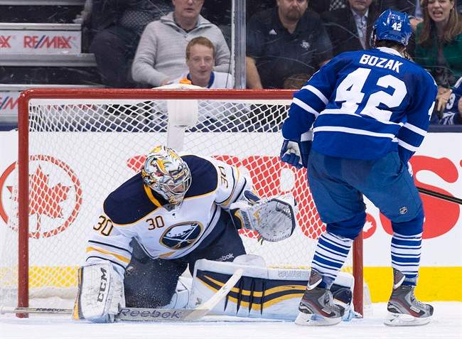 Toronto Maple Leafs forward Tyler Bozak (42) scores the game winning shoot out goal past Buffalo Sabres goalie Ryan Miller to defeat the Sabres during NHL hockey action in Toronto on January 15, 2014. THE CANADIAN PRESS/Nathan Denette.