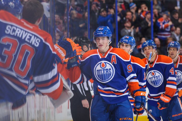 Ryan Nugent-Hopkins #93 of the Edmonton Oilers celebrates with the bench after scoring his team's third goal against the Phoenix Coyotes during an NHL game at Rexall Place on January 24, 2014 in Edmonton.