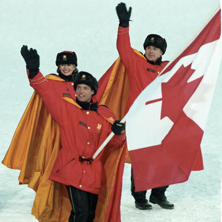 Canadian figure skater Kurt Browning carries the flag as he leads Olympic teammates onto the field during opening ceremonies for the XVII Olympics in Lillehammer Feb. 12, 1994. Ron Poling/The Canadian Press.
