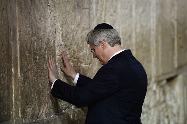 Prime Minister Stephen Harper takes a moment as he visits the Western Wall in Jerusalem, Israel on Tuesday, January 21, 2014.