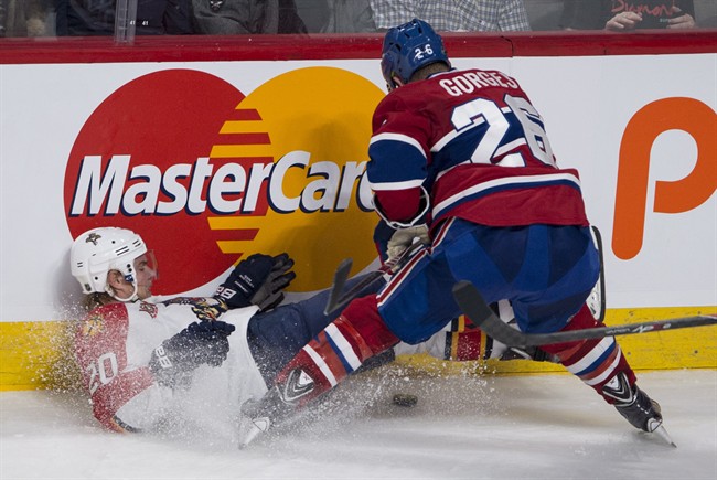 Florida Panthers' Sean Bergenheim is dumped by Montreal Canadiens' Josh Gorges during third period NHL hockey action Monday, January 6, 2014 in Montreal.