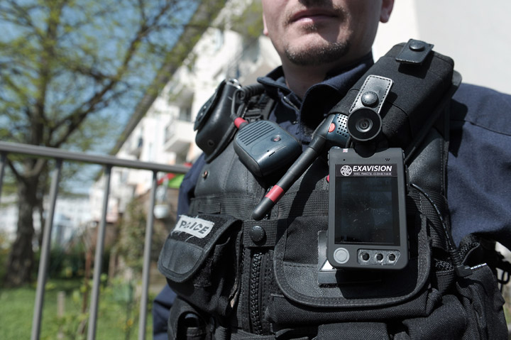 A police officer wearing a 'pedestrian camera' system poses during a control operation on May 6, 2013 in Strasbourg, eastern France.
