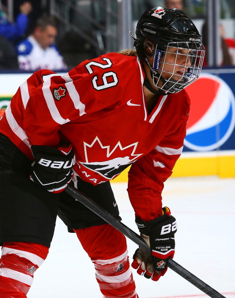 Marie-Philip Poulin #29 of Team Canada takes a face-off against Team USA during a Sochi preparation game at the Air Canada Centre December 30, 2013 in Toronto.