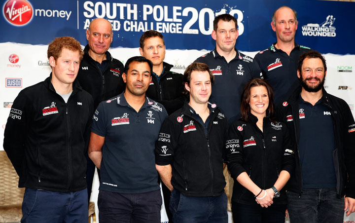 LONDON, UNITED KINGDOM - JANUARY 21: Prince Harry (L), the Expedition Patron, poses with members of the Walking With The Wounded South Pole Allied Challenge 2013 team following a welcome home news conference at Mandarin Oriental Hyde Park on January 21, 2014 in London, England. (Photo by Lefteris Pitarakis - Pool/Getty Images).