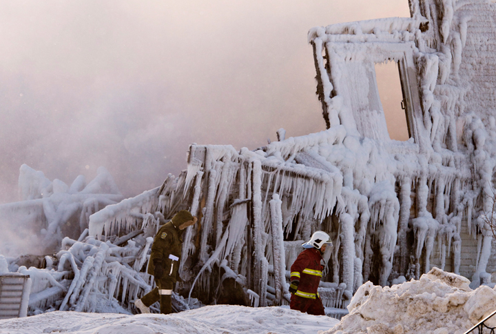 Firefighters work at the scene of a fatal fire at a seniors residence in L'Isle-Verte, Que., Thursday, January 23, 2014.