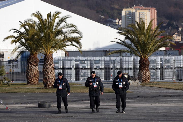 Security personnel walk in the Olympic Park in the Coastal Cluster on January 9, 2014 in Alder, Russia. 