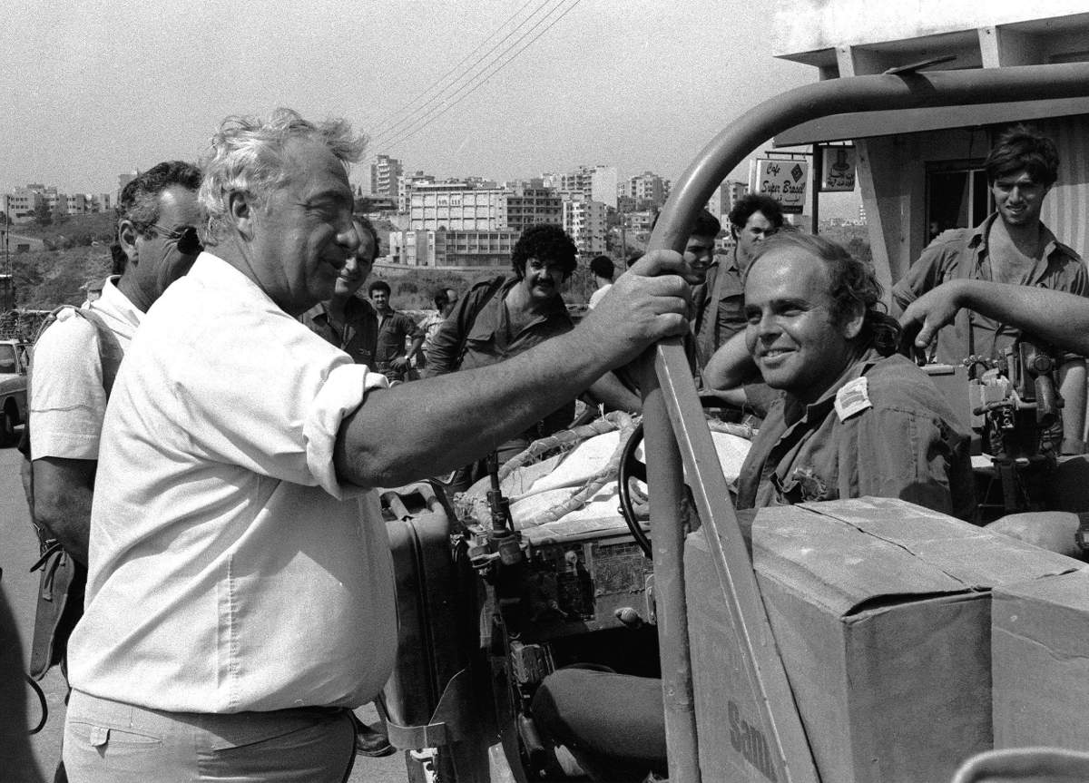 Israeli Defense Minister Ariel Sharon, left, talks with Israeli troops during a visit to east Beirut, Lebanon, in this July 2, 1982 photo. Sharon and Yasser Arafat share a long and bitter history, one that has once before come to a climax over the Palestinian leader's presence in Beirut. (AP Photo/Ari Saris)