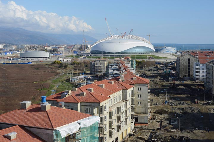 In this Tuesday, Feb. 19, 2013 file photo Olympic stadiums, from left, Ice Cube curling center, Bolshoi Ice Dome and Shaiba ice hockey center are seen in the Black Sea resort of Sochi, Russia. 