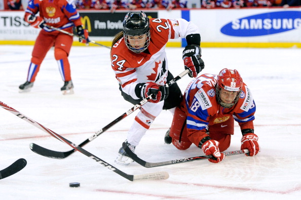  Natalie Spooner #24 of Team Canada moves the puck past Olga Sosina #18 of Team Russia during the IIHF Womens World Championship Semi-Final  game at Scotiabank Place on April 8, 2013 in Ottawa.