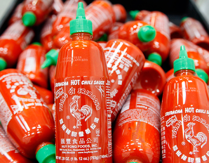 FILE - In this Oct 29, 2013 file photo, Sriracha chili sauce bottles are produced at the Huy Fong Foods factory in Irwindale, Calif. eat fiends ended the year angsting over the future of Sriracha, the trendy hot sauce with the rooster on the bottle. 