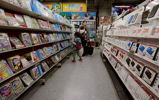 Shoppers walk through the sales floor of Nintendo 3DS video game software at an electronics store in Tokyo. Nintendo Co. says its profit for the first nine months of the fiscal year fell 30 percent because of languishing sales of its Wii U home consoles and game software.