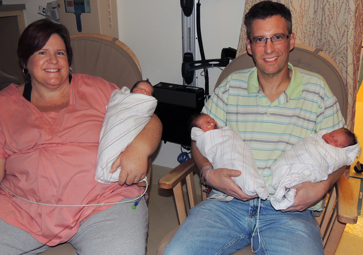 This photo taken Jan. 17, 2014 released by  Miller Children’s Hospital Long Beach, shows April and Brad Dooley holding their newly born identical triplets, from left to right, Patrick, Owen and Liam at the Long Beach Memorial, Miller Children’s Hospital in Long Beach, Calif. 