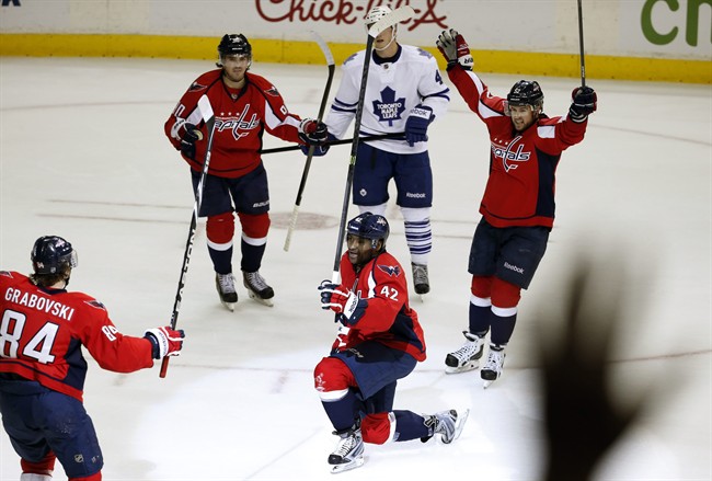 Washington Capitals right wing Joel Ward (42) celebrates his goal with center Mikhail Grabovski (84), center Marcus Johansson (90) and defenseman Mike Green (52), with Toronto Maple Leafs center Tyler Bozak (42) nearby, during the third period of an NHL hockey game, Friday, Jan. 10, 2014, in Washington.