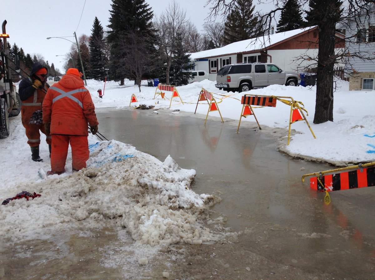 City crews work at the site of a water main break on Laxdal Road Sunday.
