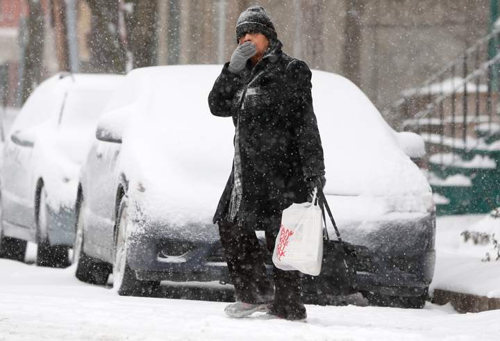 A pedestrian walks through morning snow, Thursday, Jan. 2, 2014, in Albany, N.Y. (Photo credit: AP Photo)
