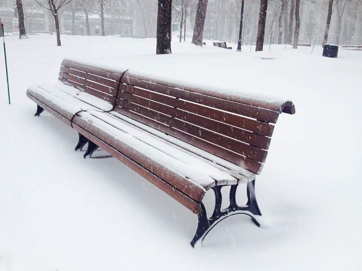 A park bench covered with a sprinkle of fresh snow in Montreal on January 27, 2014.