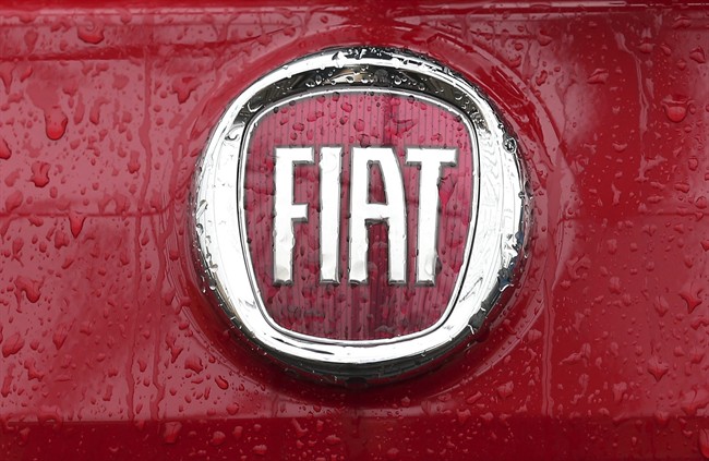 Rain falls on a Fiat logo pictured on a car in Milan, Italy, Thursday, Jan. 2, 2014.