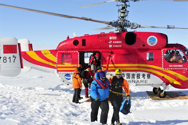In this photo provided China’s official Xinhnua News Agency, the first group of passengers of the trapped Russian ship MV Akademik Shokalskiy arrive at a safe surface off the Antarctic Thursday, Jan. 2, 2014.