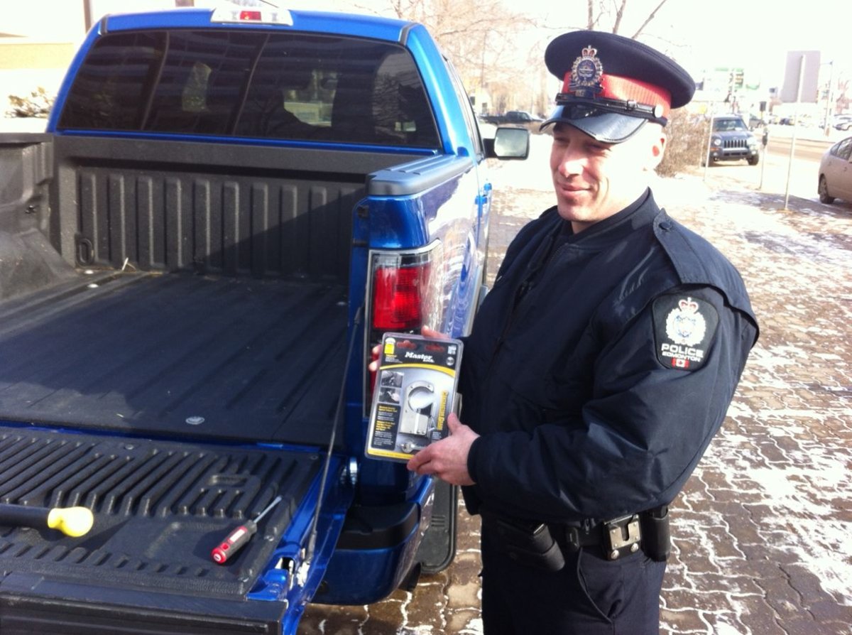 Cst David Webber shows an inexpensive tailgate lock in Edmonton, Feb. 13, 2014.