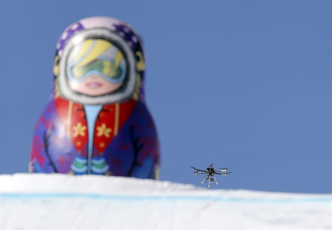 In this Friday Feb. 7 photo, a drone camera flies about the slopestyle course during a freestyle skiing slopestyle training session at the Rosa Khutor Extreme Park ahead of the 2014 Winter Olympics, Friday, Feb. 7, 2014, in Krasnaya Polyana, Russia. 
