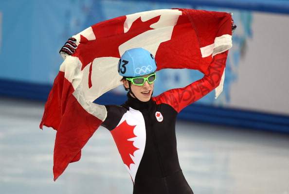 Canada’s Charle Cournoyer celebrates after winning the bronze medal in the Men’s Short Track 500 m Final at the Iceberg Skating Palace during the Sochi Winter Olympics on February 21, 2014.