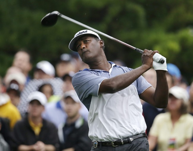 In this Aug. 9, 2013, photo, Vijay Singh, of Fiji, watches his tee shot on the 10th hole during the second round of the PGA Championship golf tournament at Oak Hill Country Club in Pittsford, N.Y. 