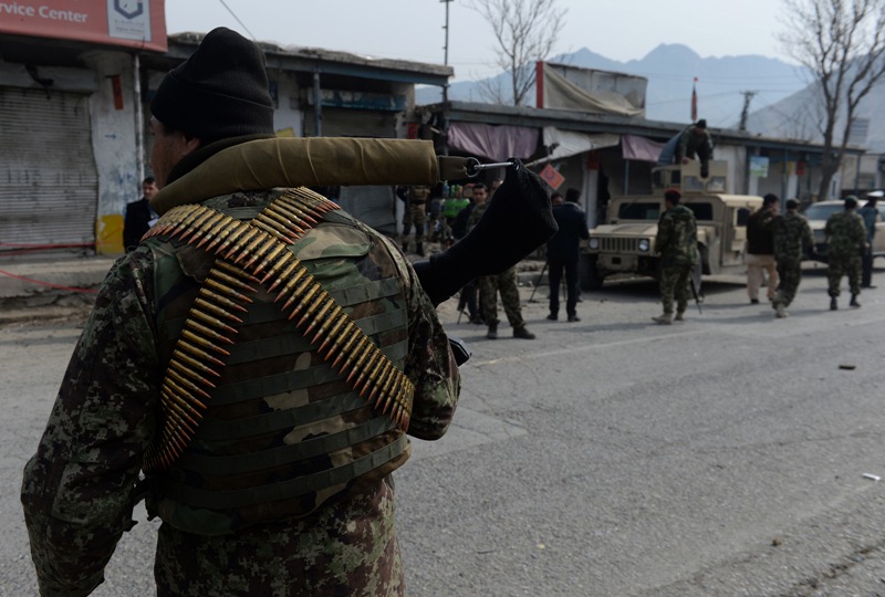Afghan security personnel are pictured at the scene of a suicide bombing in Sarobi district of Kabul province on February 21, 2014. AFP PHOTO/SHAH Marai.