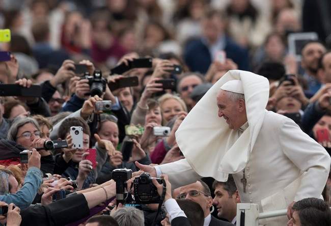 Pope Francis is greeted by the faithful… and the wind.