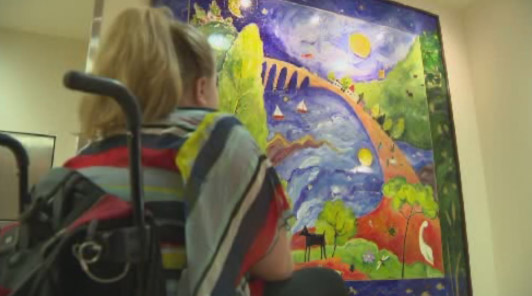 A patient looks at a piece of artwork at Holland Bloorview Kids Rehabilitation Hospital.