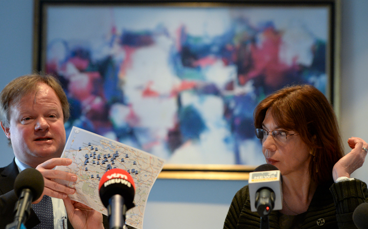 Professor Stefaan Van Gool (L) of UZ Leuven university, flanked by Professor Nadine Francotte from CHC clinic in Liege, shows a map during a press conference of pediatricians on the expansion of the euthanasia law for minors, in Brussels, on February 11, 2014.