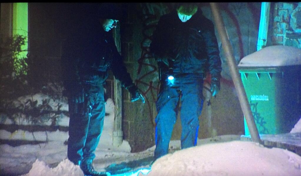 Police search the ground outside an apartment building on Tower Terrace.