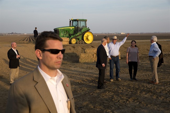 President Barack Obama, second from left in group, tours a local farm with Governor Jerry Brown, left, Joe Del Bosque of Empresas Del Bosque, Inc., and Maria Gloria Del Bosque also of Empresas Del Bosque, Inc.,and Rep. Jim Costa, D-Calif., in Los Banos, Calif., Friday, Feb. 14, 2014, where he spoke about the drought. (AP Photo/Jacquelyn Martin).