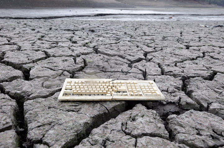 A discarded computer keyboard lies on the dry, cracked bed of the Almaden Reservoir in San Jose, Calif. on Friday, Feb. 7, 2014 during the state’s worst drought in recorded history.