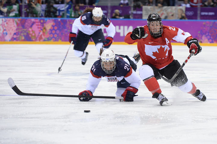 USA defenseman Anne Schleper (15) cross checks Canada forward Jayna Hefford  (16) in the second period of the women's hockey gold medal game at the  Bolshoy Ice Dome during the Winter Olympics