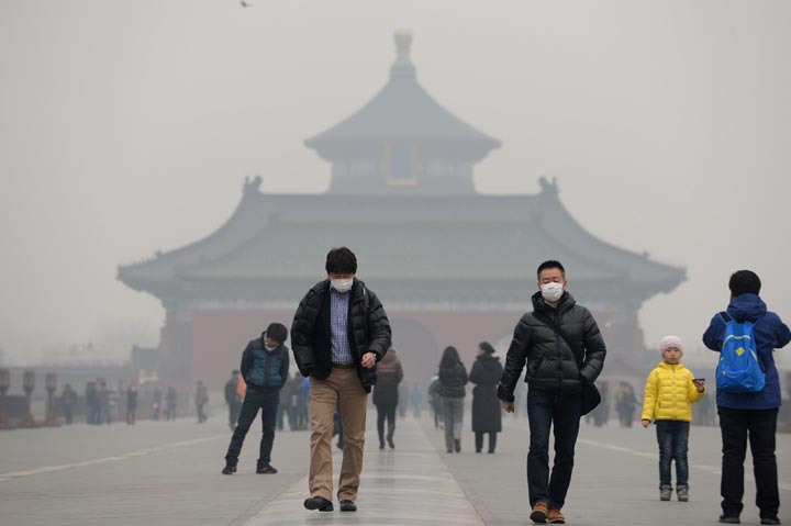 This picture taken on February 24, 2014 shows visitors wearing masks in Temple of Heaven in haze-covered Beijing. (Stringer/AFP/Getty Images)