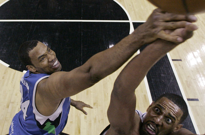 FILE - In a March 17, 2009, file photo Minnesota Timberwolves center Jason Collins, left, defends San Antonio Spurs center Kurt Thomas during the first quarter of an NBA basketball game in San Antonio.