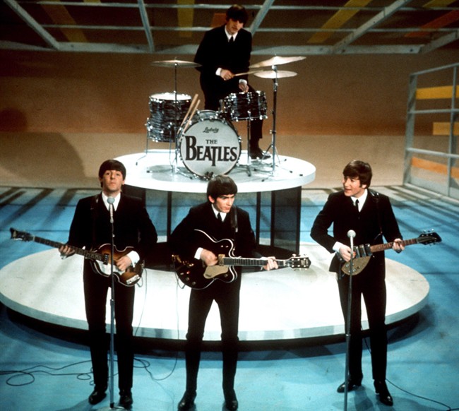 The Beatles, from left, Paul McCartney, George Harrison, Ringo Starr on drums, and John Lennon perform on the CBS "Ed Sullivan Show" in New York in this Feb. 9, 1964 file photo.