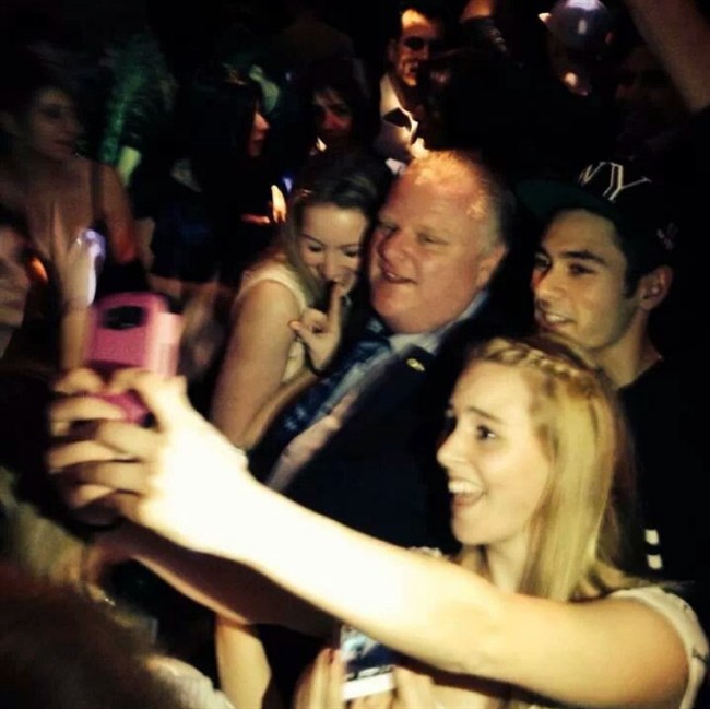 Toronto Mayor Rob Ford poses for photos at the Foggy Dew pub in Coquitlam, B.C., on Friday night, Feb. 1, 2014. THE CANADIAN PRESS/Catriona Korucu.