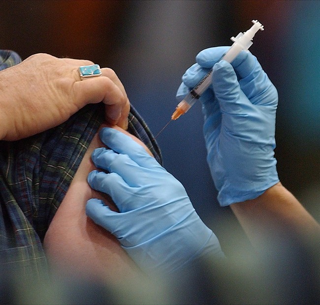 FILE - A flu shot is given to a patient. 
