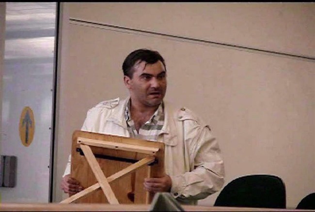 Robert Dziekanski holds a small table at the Vancouver Airport before he was tasered by police in this image from video.