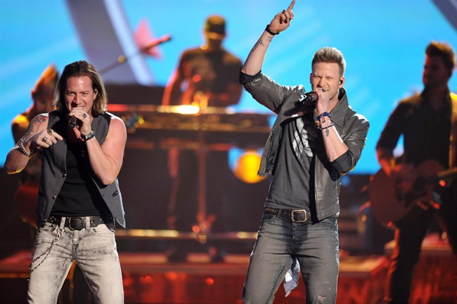 Tyler Hubbard, left, and Brian Kelley of the musical group Florida-Georgia Line perform on stage at the American Music Awards at the Nokia Theatre L.A. Live on Sunday, Nov. 24, 2013, in Los Angeles.".