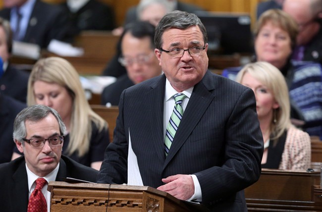 Finance Minister Jim Flaherty tables the federal budget in the House of Commons on Parliament Hill in Ottawa on Tuesday, February 11, 2014. Many middle-class families are struggling economically, but at least one of them is doing quite well, thank you very much: the working parents and two kids who appear as a fictitious examples in the federal budget each year. 
