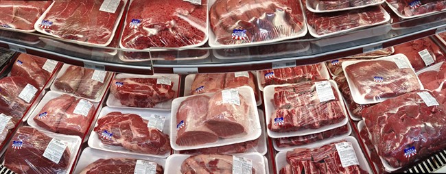 In this Nov. 2, 2013 file photo, various cuts of beef and pork are displayed in Arlington, Va.