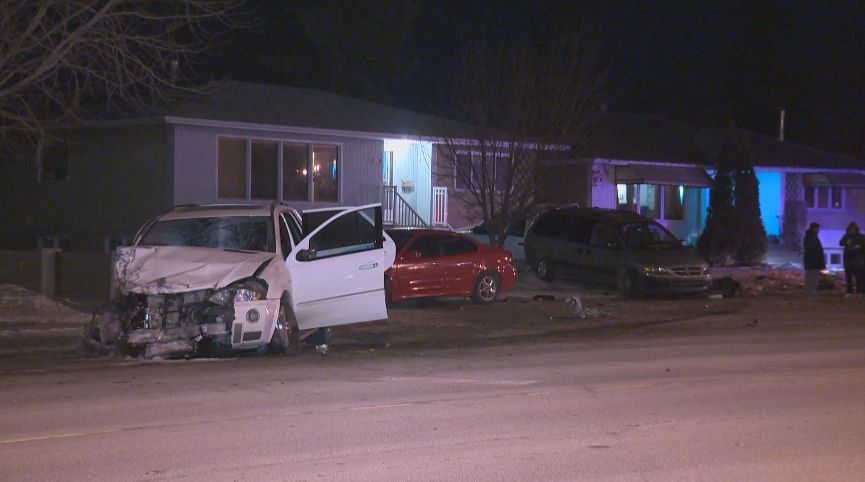 Edmonton police investigate a collision that results in multiple vehicles and a home being damaged, Thursday, Feb. 27, 2014. 