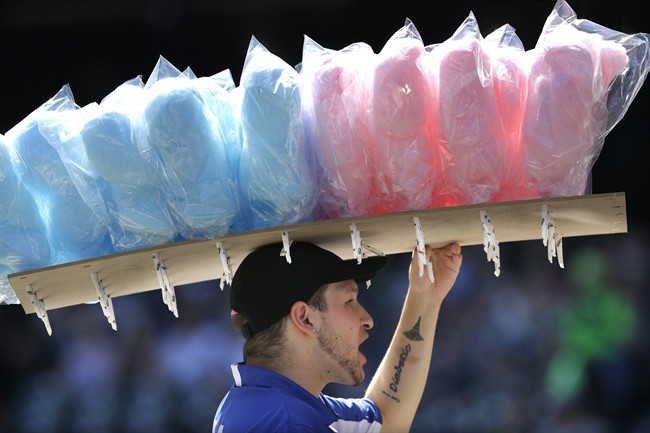 In this Sept. 8, 2013 file photo, a vendor sells cotton candy at Safeco field during a baseball game between the Tampa Bay Rays and the Seattle Mariners, in Seattle.